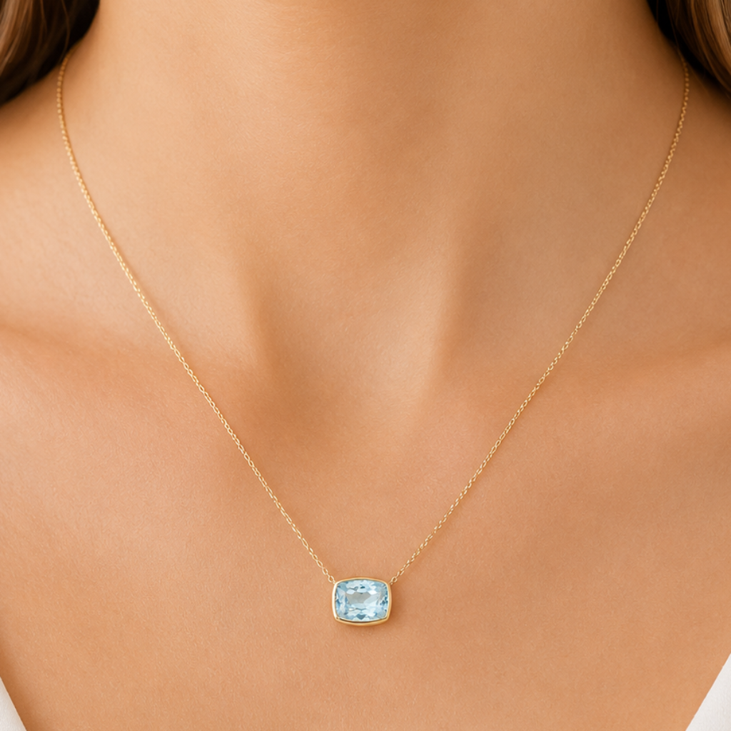 model wearing 14k yellow gold aquamarine pendant necklace
