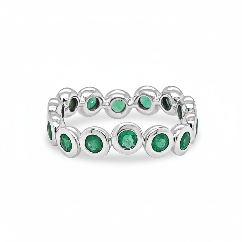 18k white gold ring with bezel-set round emeralds totaling 0.95 carats