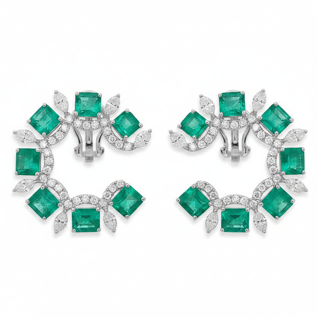18k white gold earrings with pear emerald drops and marquise diamond accents in an arc design