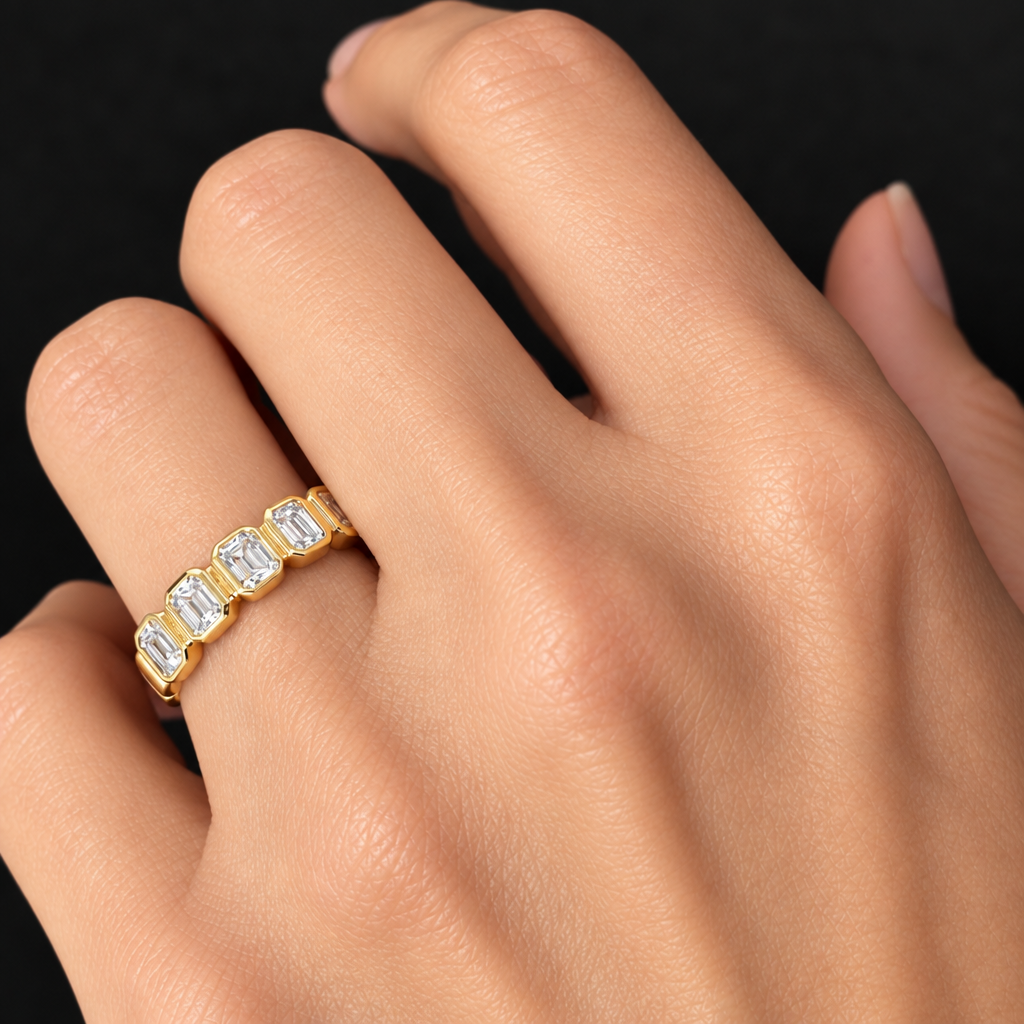 Five emerald-cut diamond ring in 18k yellow gold worn on hand