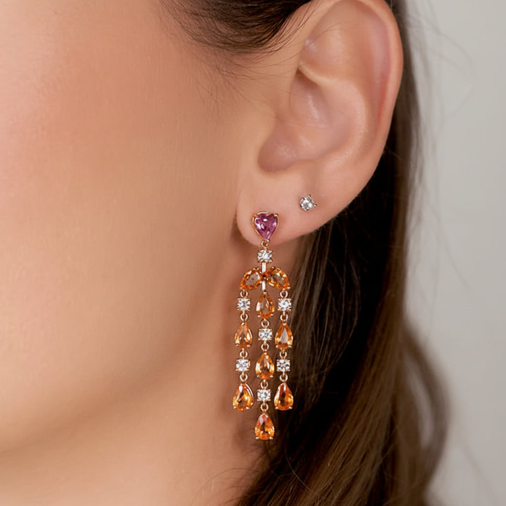 18k gold chandelier earrings with pear-shaped orange sapphires and diamond accents