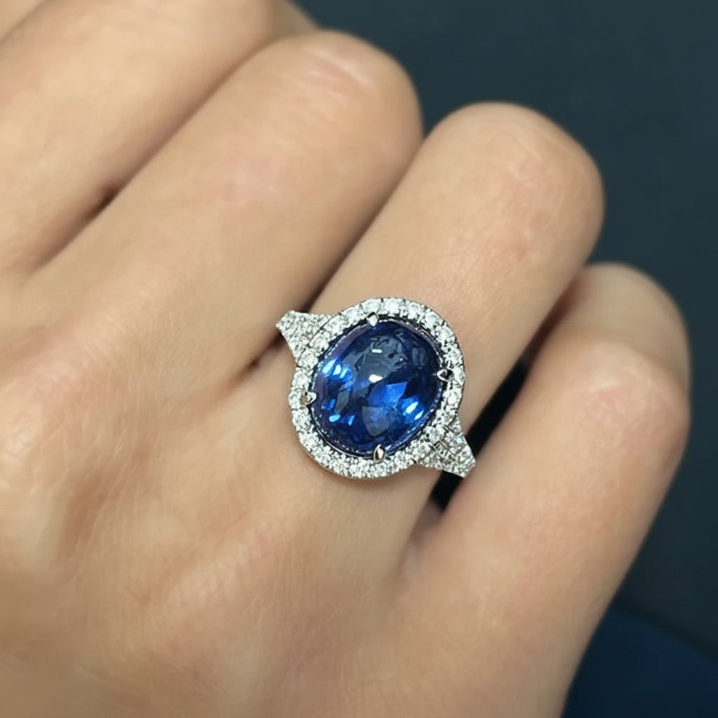 18k gold ring with oval blue sapphire double cabochon and diamond halo