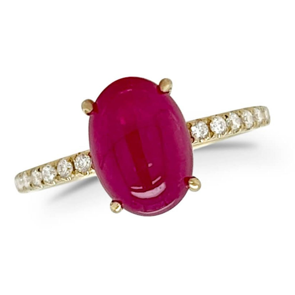 18k yellow gold band featuring an oval ruby cabochon and round diamond accents