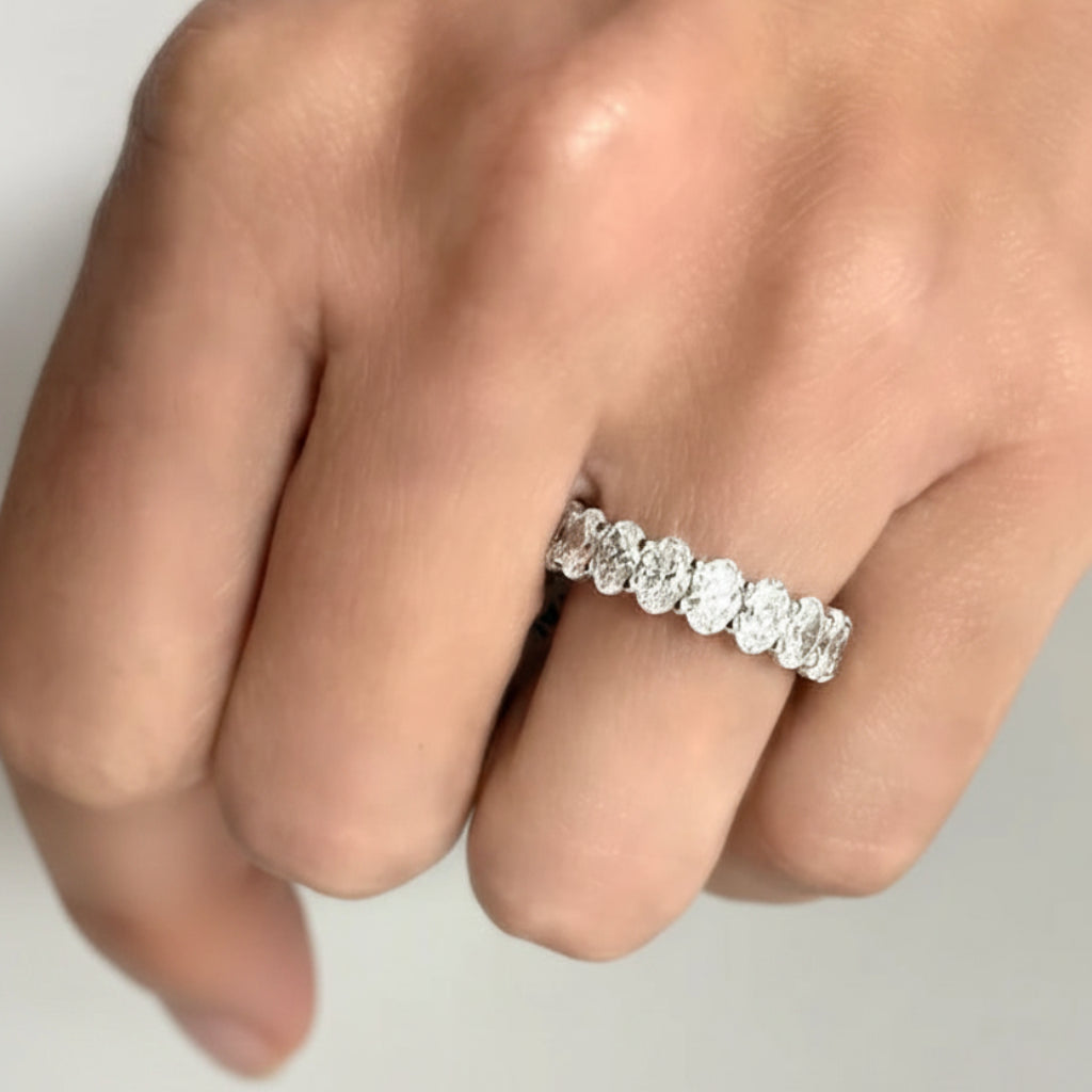 platinum eternity band with oval-cut diamonds totaling 4.54 cts