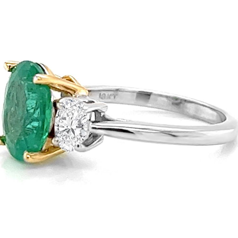 18k gold ring with oval emerald and oval diamond side stones