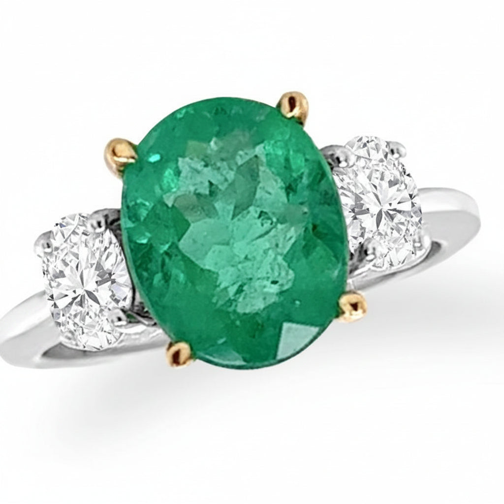 18k gold ring with oval emerald and oval diamond side stones