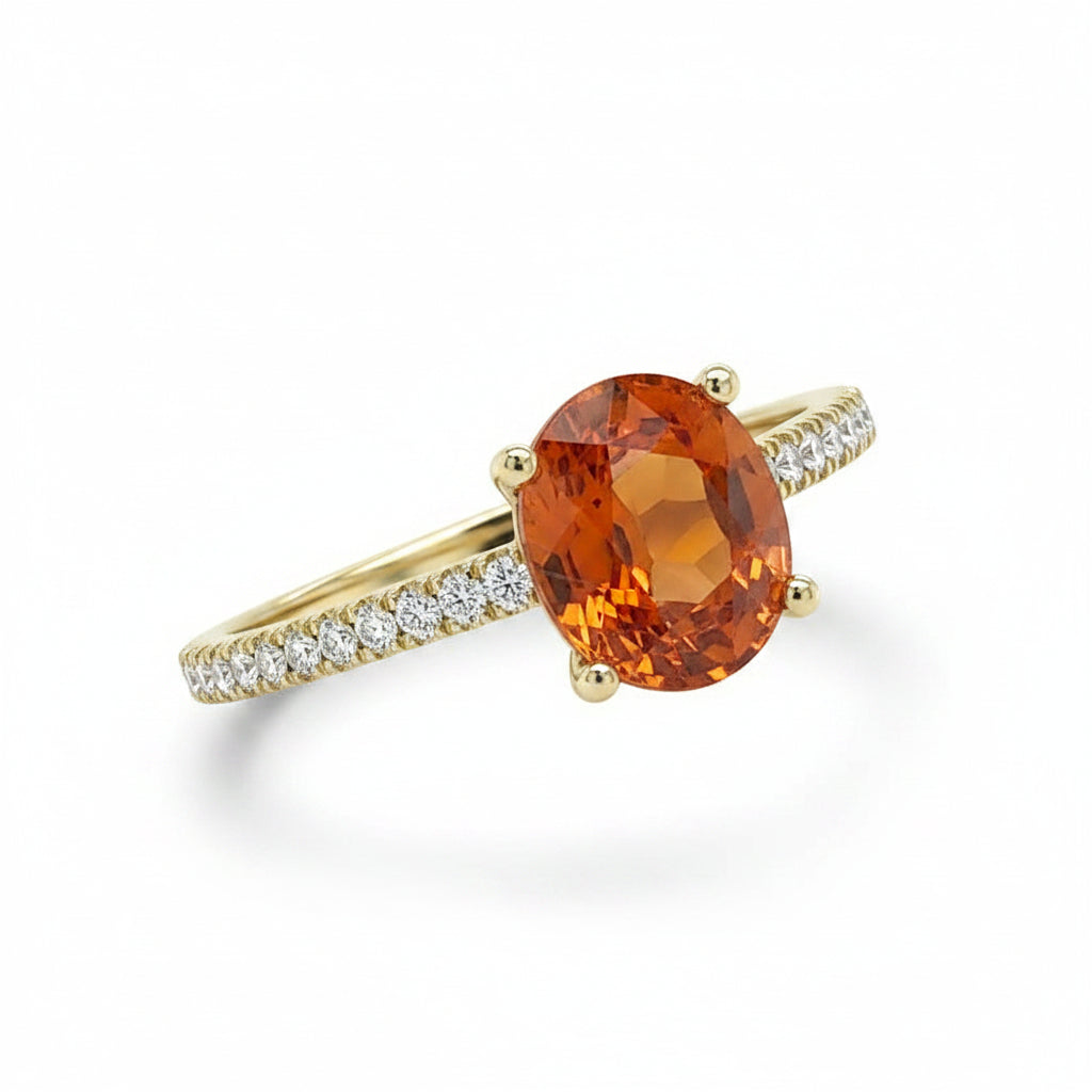 18k yellow gold ring with oval mandarin garnet center and diamond halo with pave shank