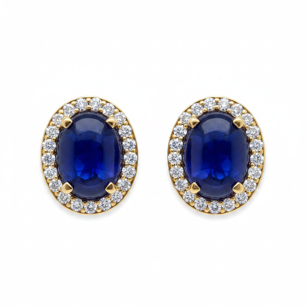 18k yellow gold stud earrings featuring oval sapphire cabochons framed by diamond halos