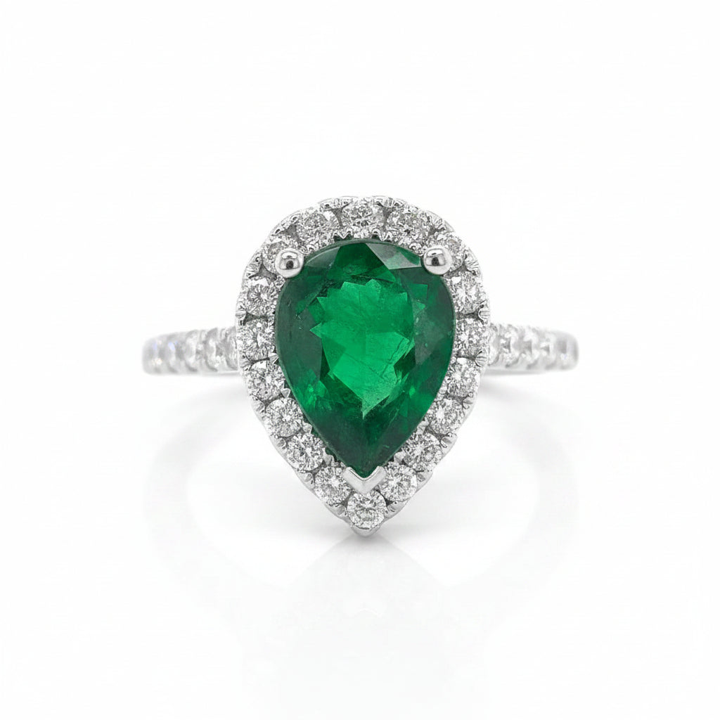 18k white gold ring with a pear-shaped GIA emerald and diamond pave surround