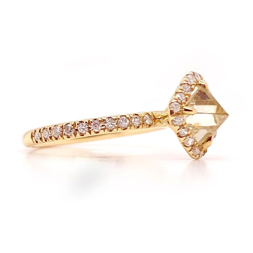 18k yellow gold ring with a raw rough diamond and diamond accents—modern, organic, and easy to style.
