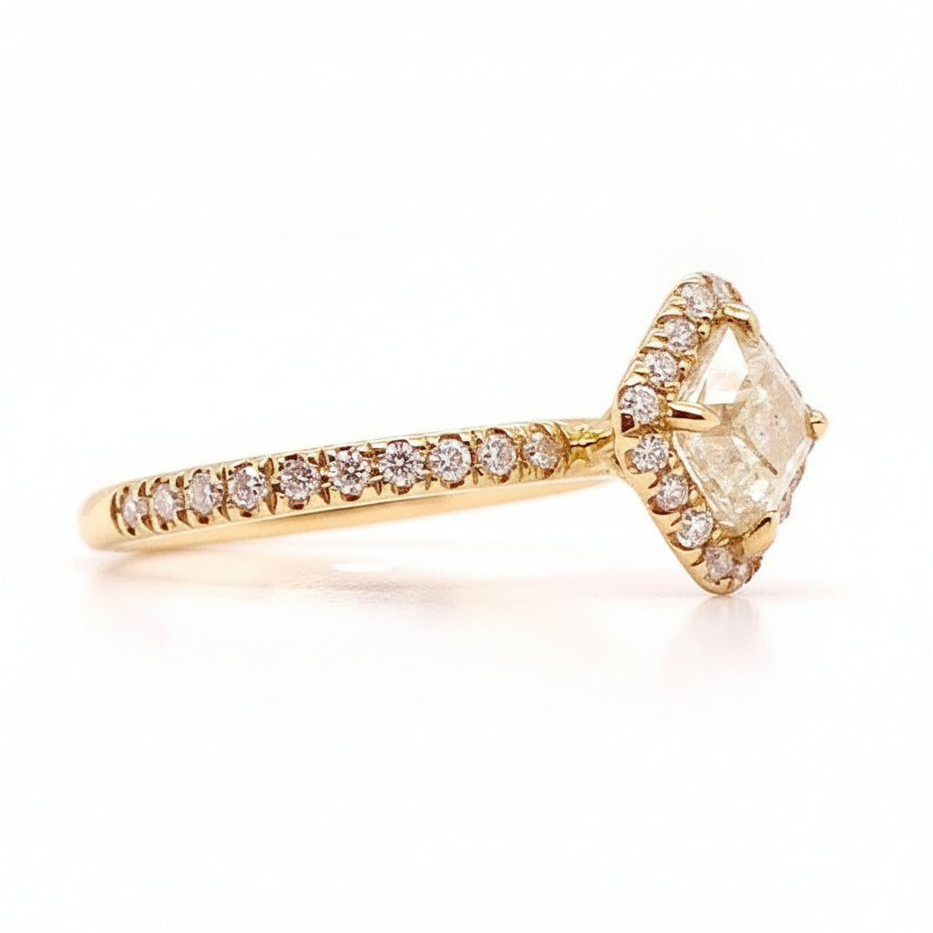 18k yellow gold ring with a raw rough diamond and diamond accents—modern, organic, and easy to style.