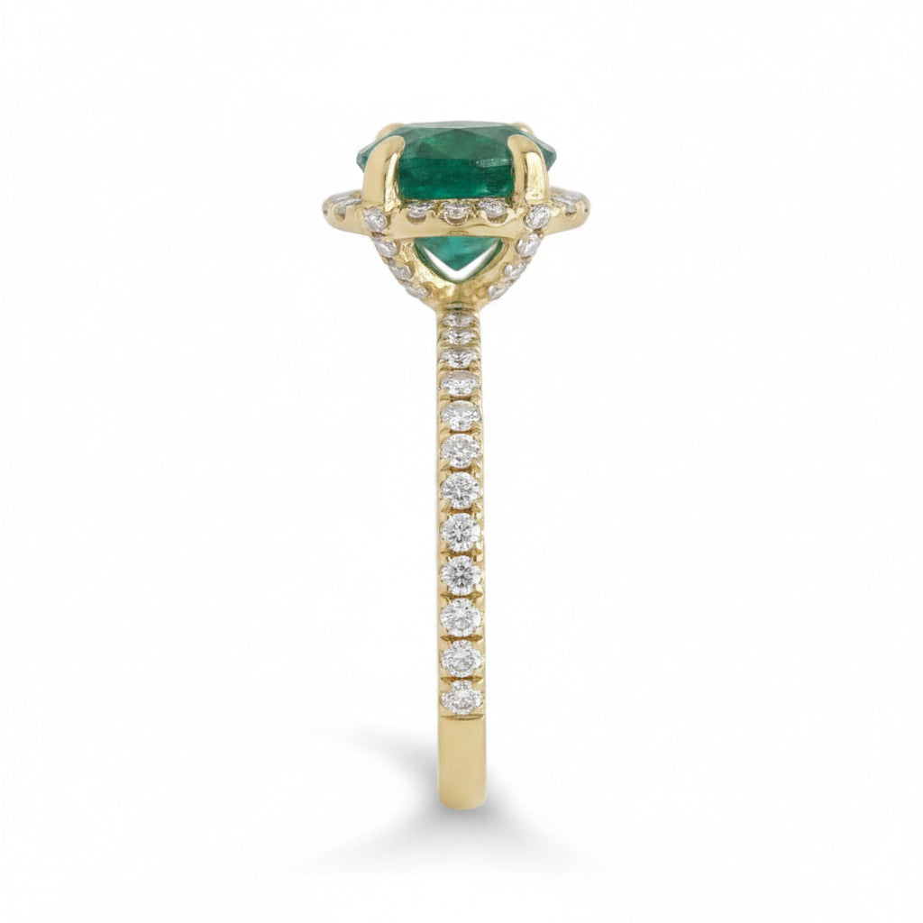 18k yellow gold ring with a round emerald center and surrounding diamonds