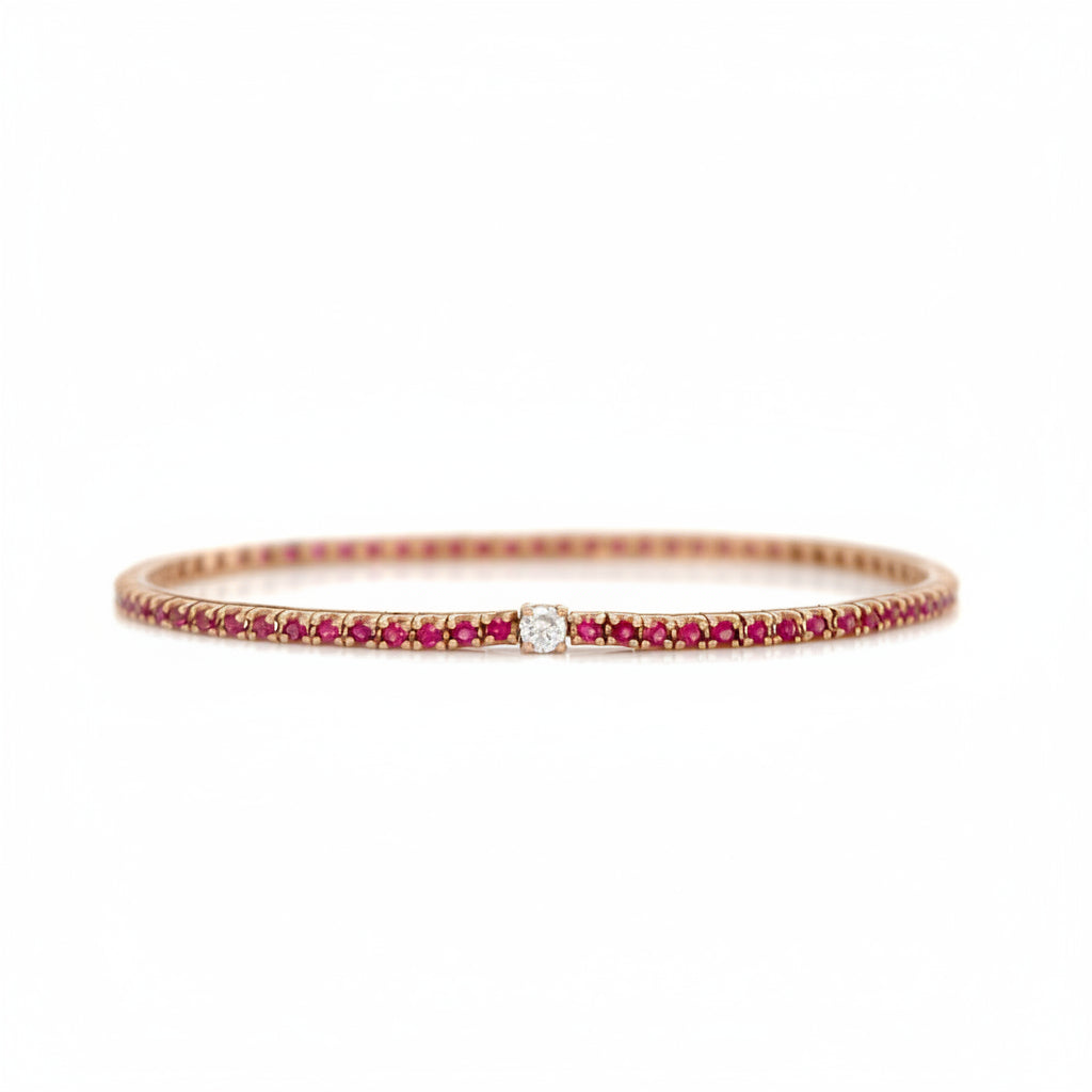 18k yellow gold tennis bracelet with red ruby links and a central diamond detail
