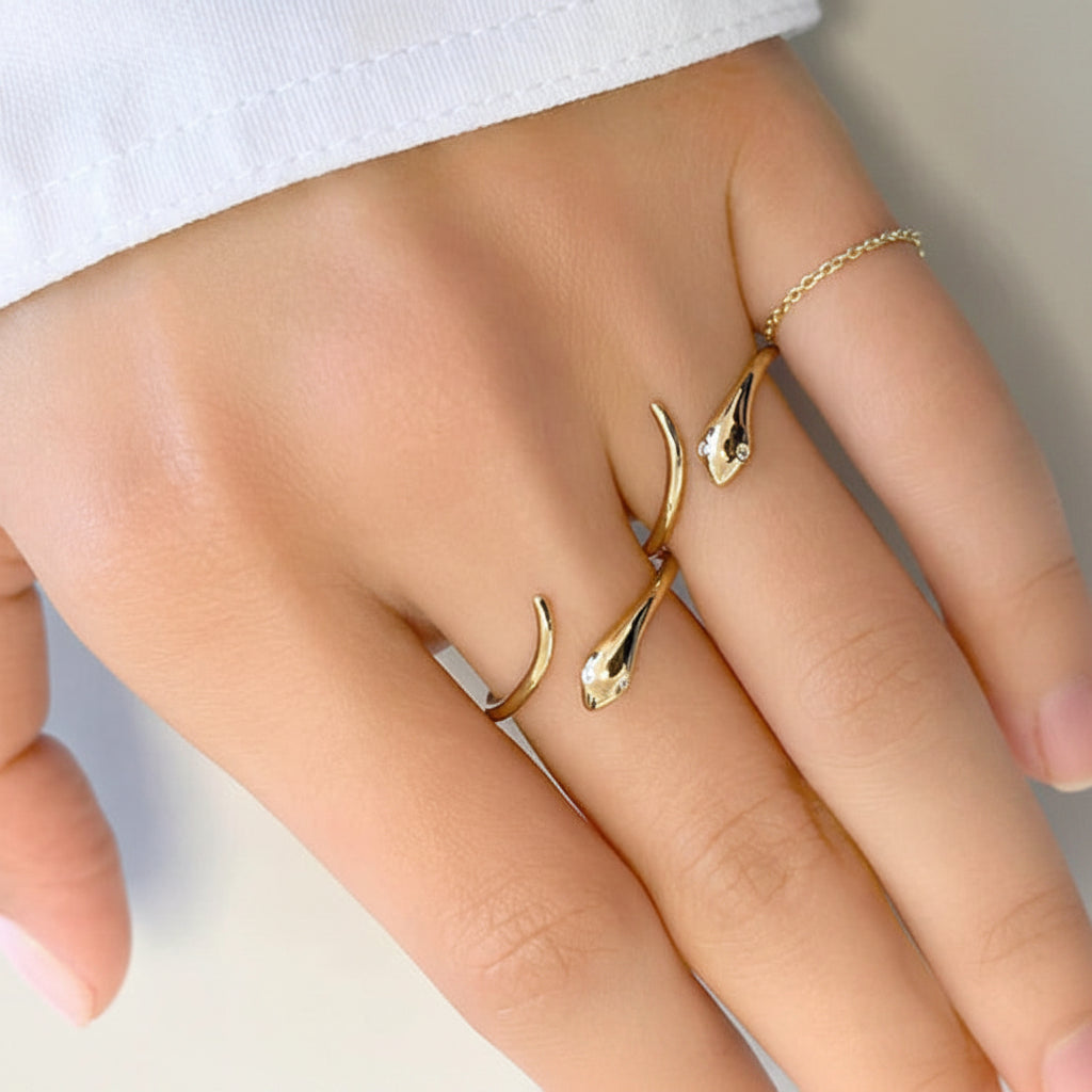 14k rose gold ring shaped as a coiled snake with diamond-set eyes