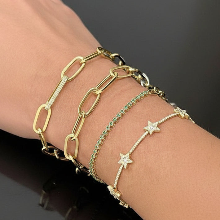 14k gold bracelet with star motifs and round brilliant diamonds by Diamond Tales