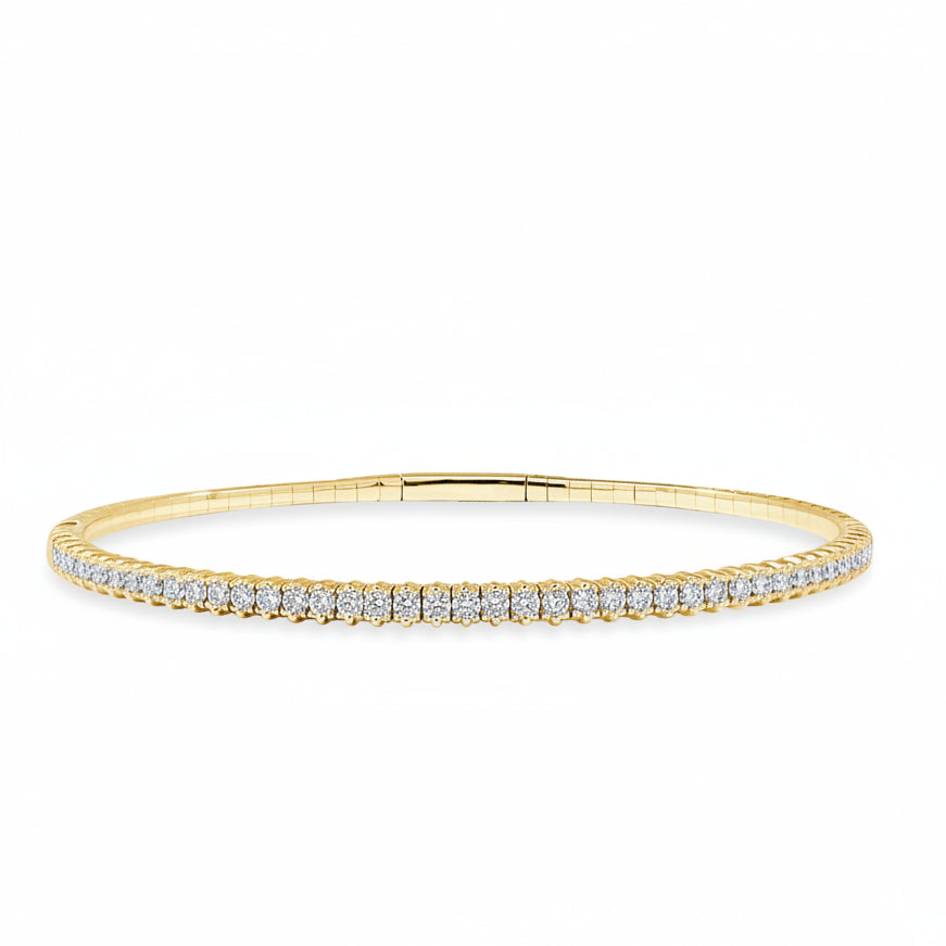 rigid 14k yellow gold tennis bangle bracelet with round diamonds encircling the band