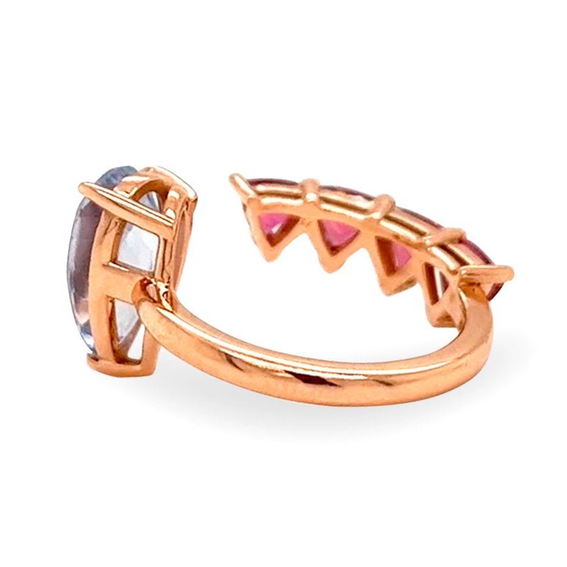 18k gold ring with pear sapphire and trillion-cut rubellite in a bypass design