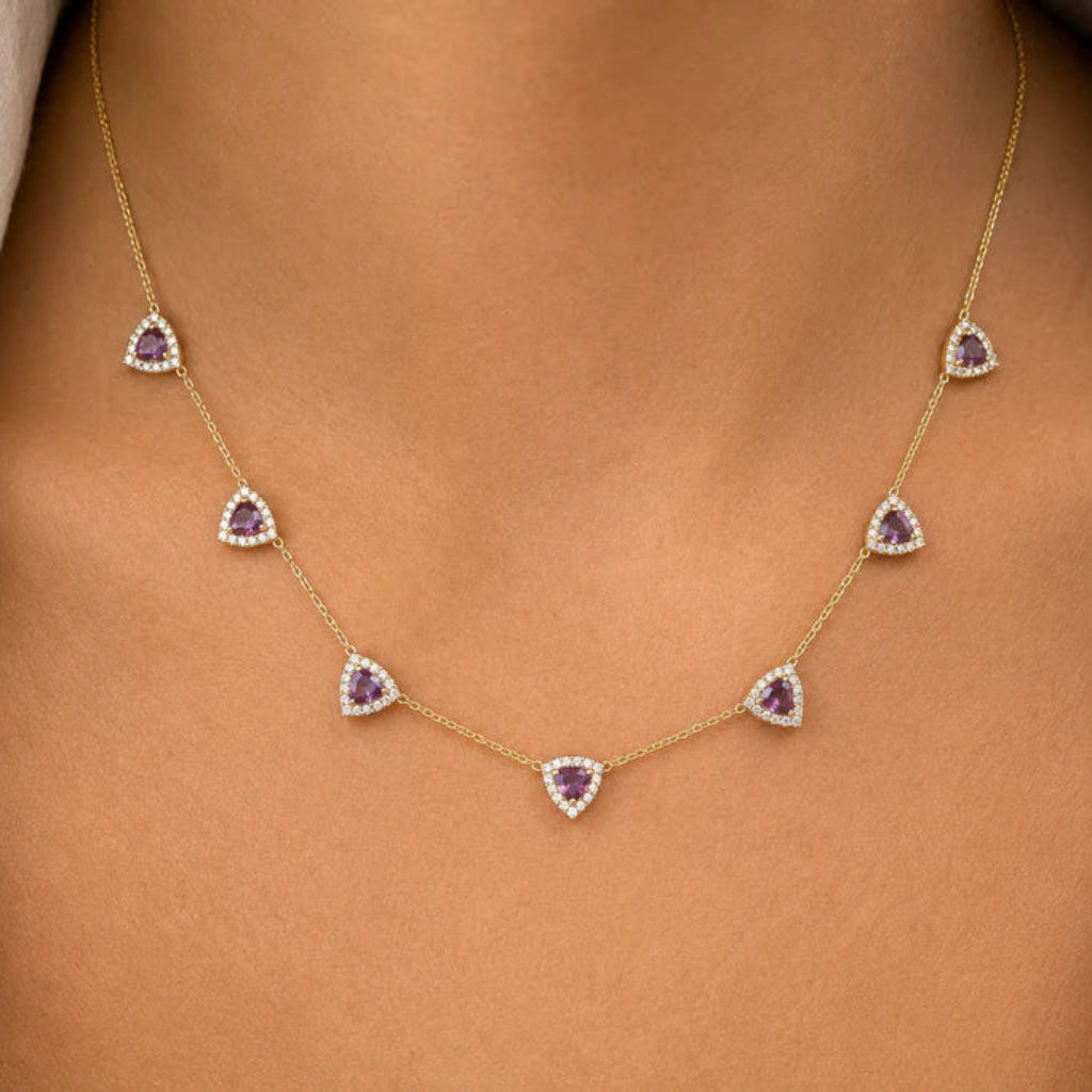 14k gold necklace with seven trillion-cut amethyst stones and round diamond accents