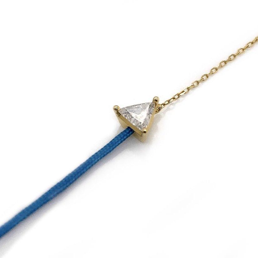 18k gold chain and silk cord bracelet with trillion-cut diamond centerpiece