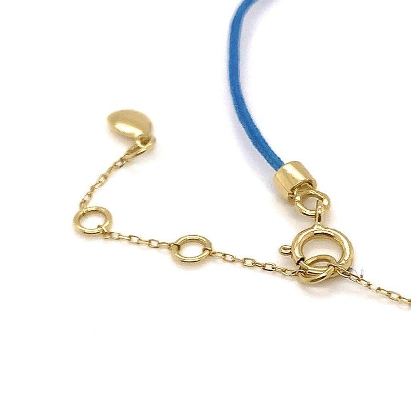 18k gold chain and silk cord bracelet with trillion-cut diamond centerpiece