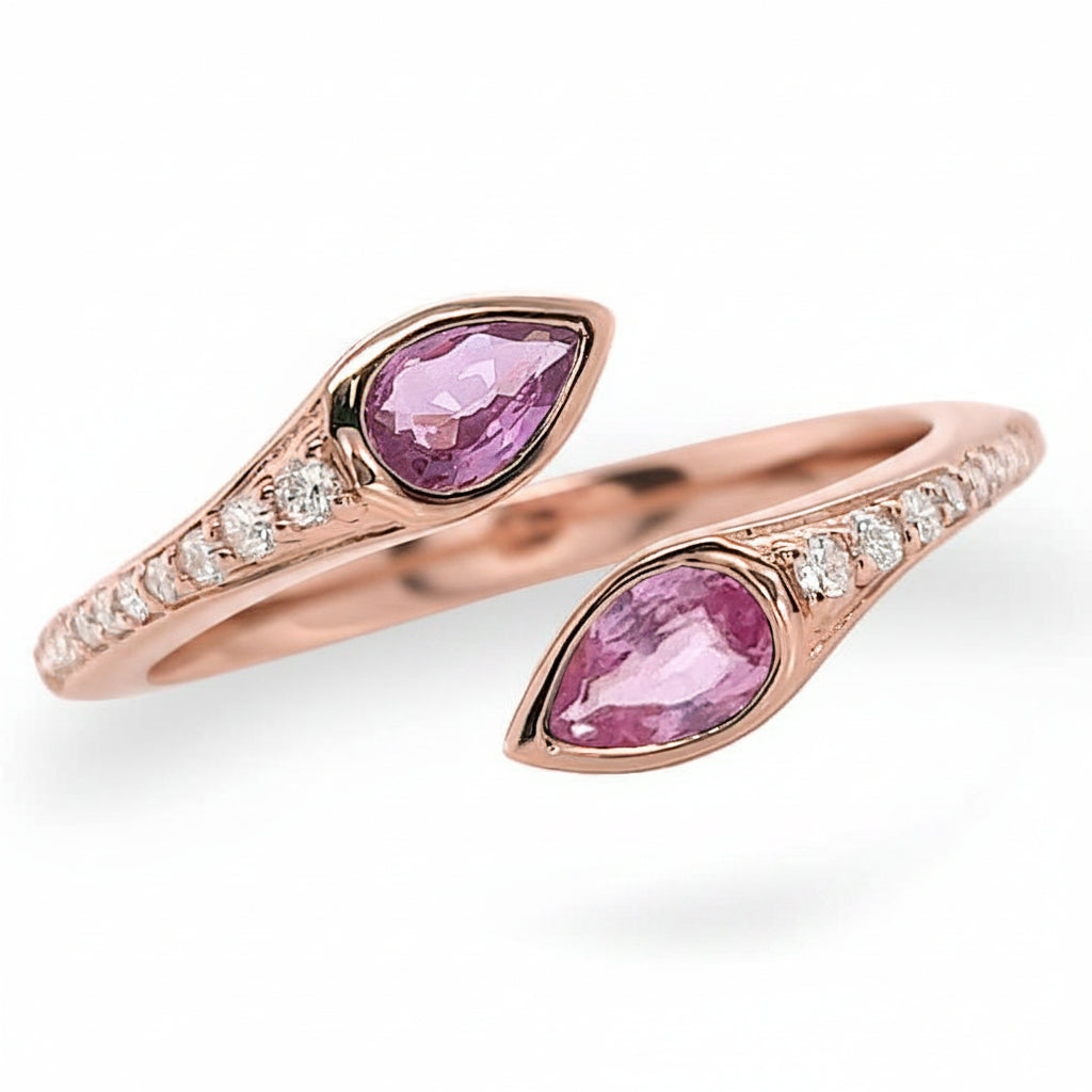 18k gold ring with two pear sapphires and a round diamond accent