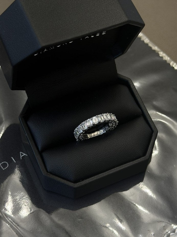 Step-cut diamond eternity band in white gold in a Diamond Tales ring box