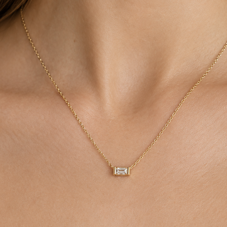 Close-up of the emerald-cut diamond and 14k yellow gold chain on an adjustable necklace