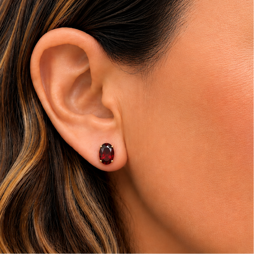 close up of 14k gold oval garnet stud earrings detail