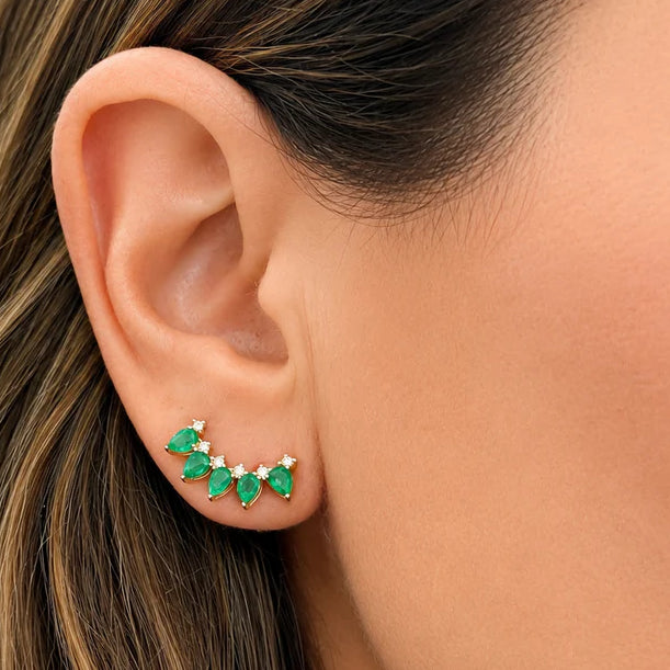 close up of pear emerald diamond crawler earrings detail
