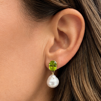 close up of south sea pearl and peridot drop earrings 14k yellow gold