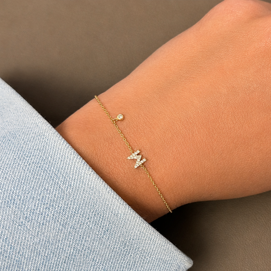 diamond letter bracelet in 14k gold with bezel set diamond accent close up detail
