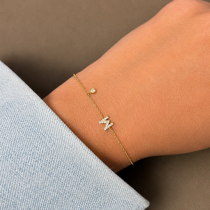 diamond letter bracelet in 14k gold with bezel set diamond accent close up detail