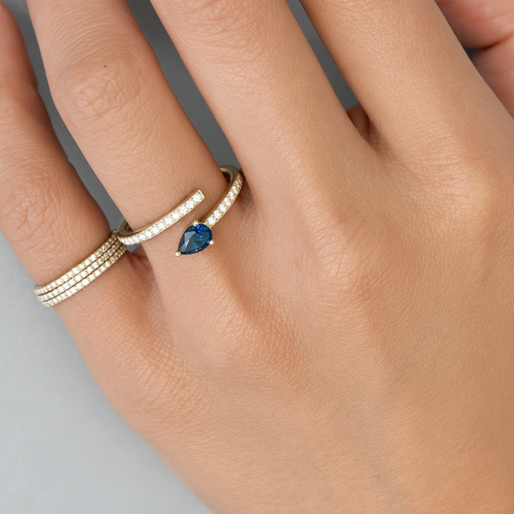 14k yellow gold spring ring with 0.48 ct pear sapphire and 0.14 cts diamonds