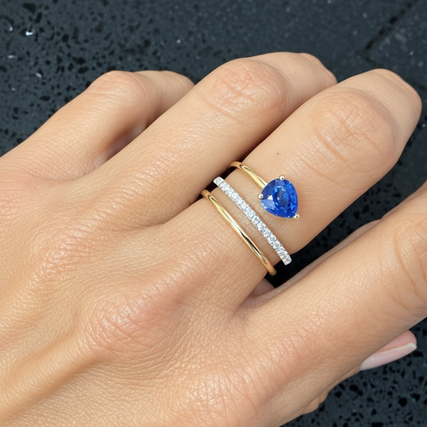 Detail of the open spiral setting and diamond-set coil on a blue sapphire cocktail ring