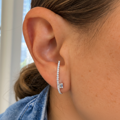 Detail of pave-set round diamonds along an 18k white gold ear climber