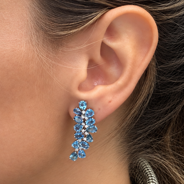 Detail of graduated pear-cut aquamarines and diamonds on an 18k white gold ear climber