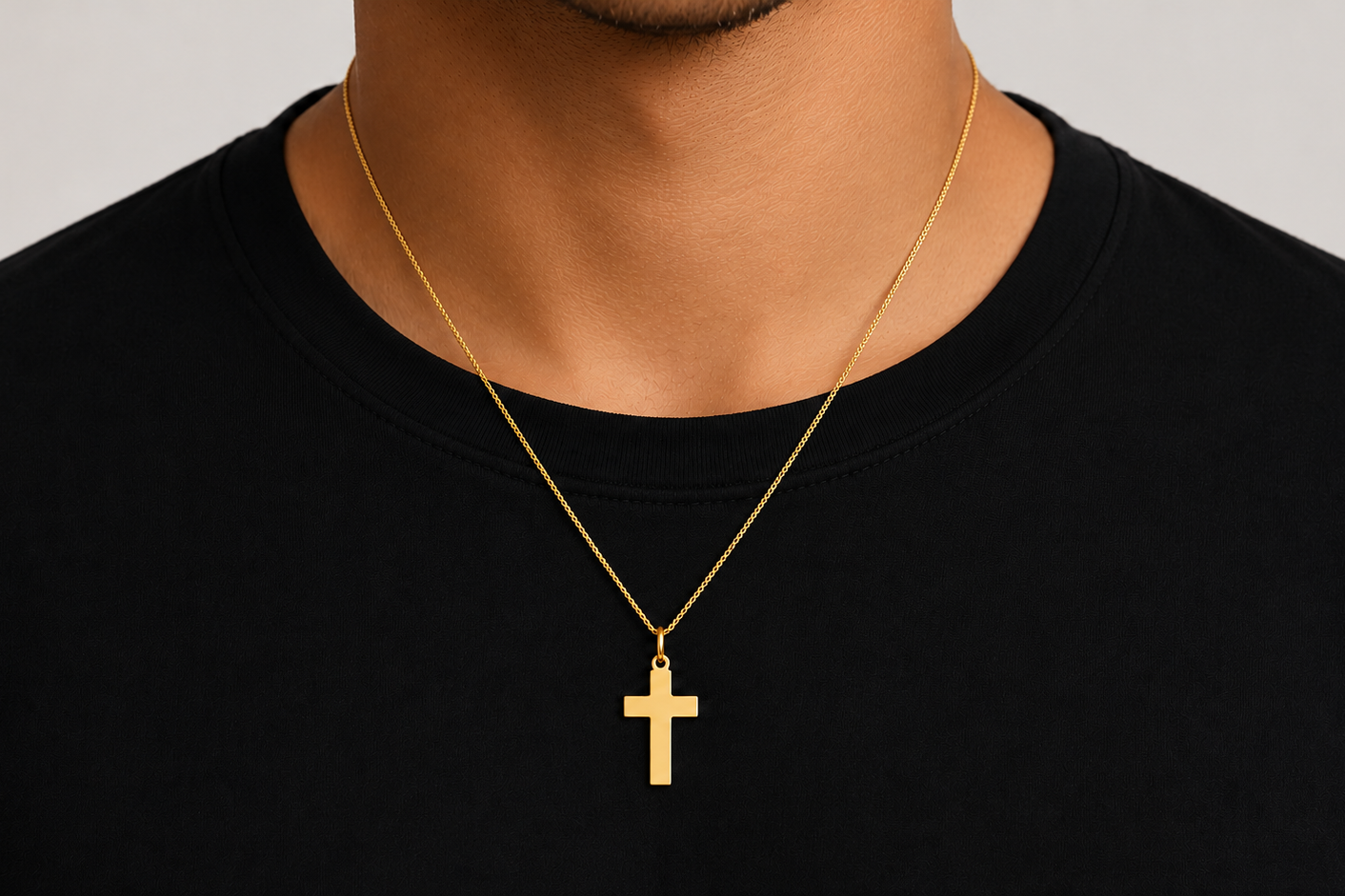 polished 14k gold cross pendant, close up