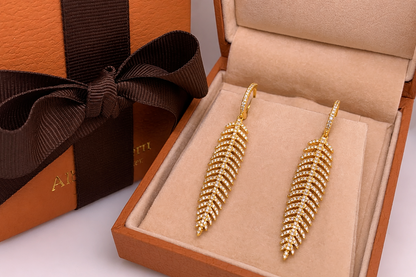 18k gold and diamond feather earrings worn, close up