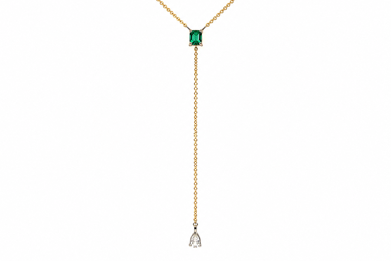 pear shaped diamond drop with bezel set diamond accents, close up