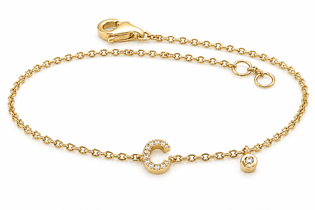 14kt gold initial bracelet with bezel-set diamond accent worn on wrist