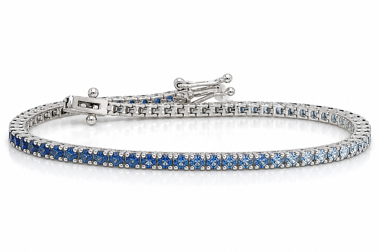 14kt white gold tennis bracelet with gradient of natural blue sapphires by Albert Hern