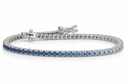 14kt white gold tennis bracelet with gradient of natural blue sapphires by Albert Hern
