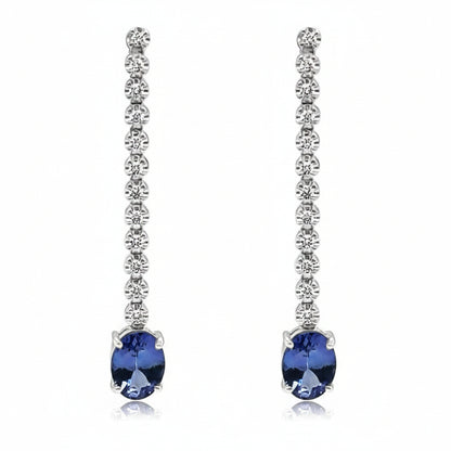 18k white gold drop earrings with inline diamonds and oval tanzanita drops
