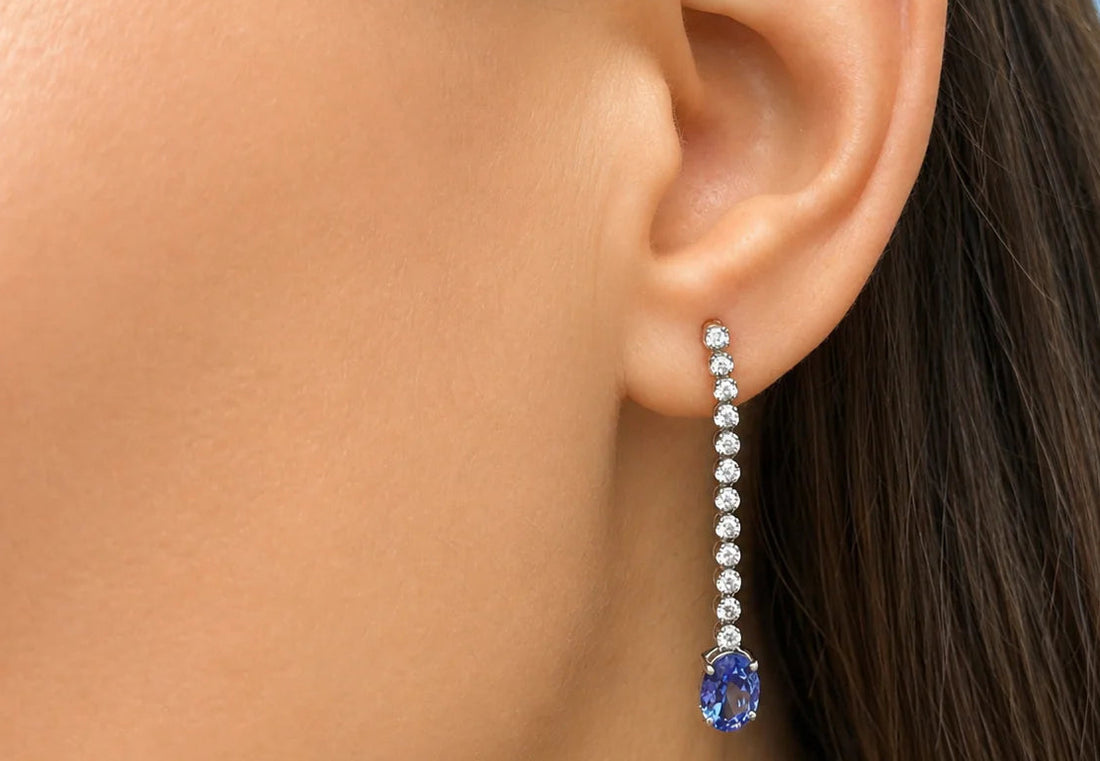18k white gold drop earrings with inline diamonds and oval tanzanita drops