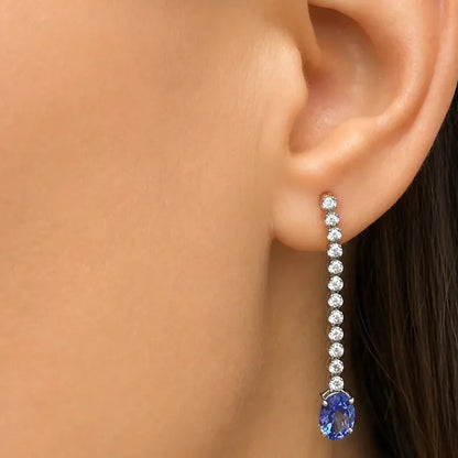 18k white gold drop earrings with inline diamonds and oval tanzanita drops
