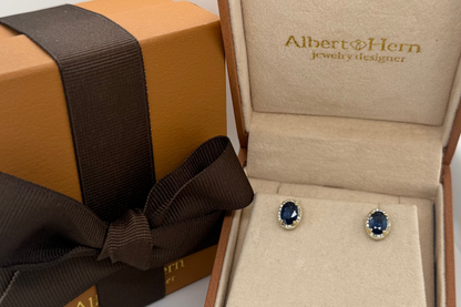 sapphire halo stud earrings worn on the ear, close up