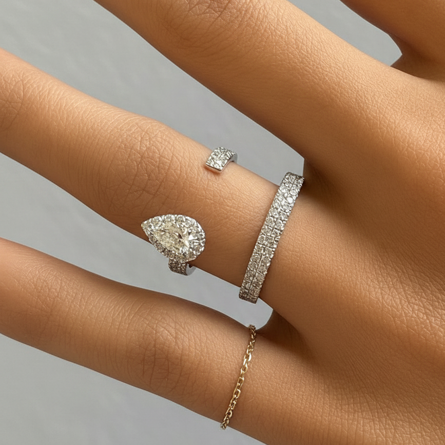 18k gold open ring with pear-shaped and round diamonds in a modern fine jewelry design by Diamond Tales.