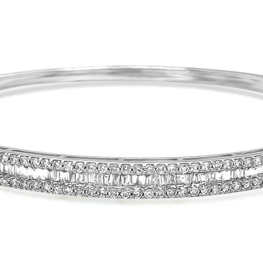 18k gold bangle bracelet with baguette and round brilliant diamonds by Diamond Tales