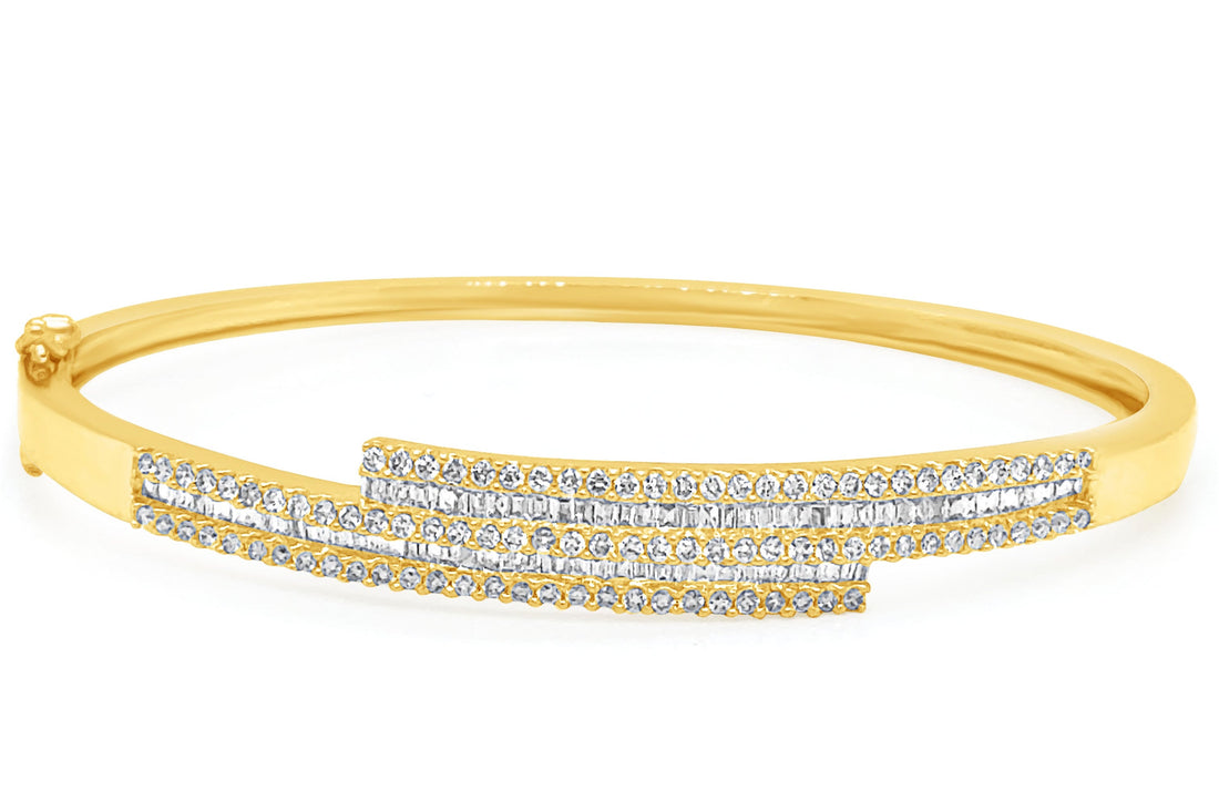 18k gold bangle bracelet with baguette and round brilliant diamonds by Diamond Tales
