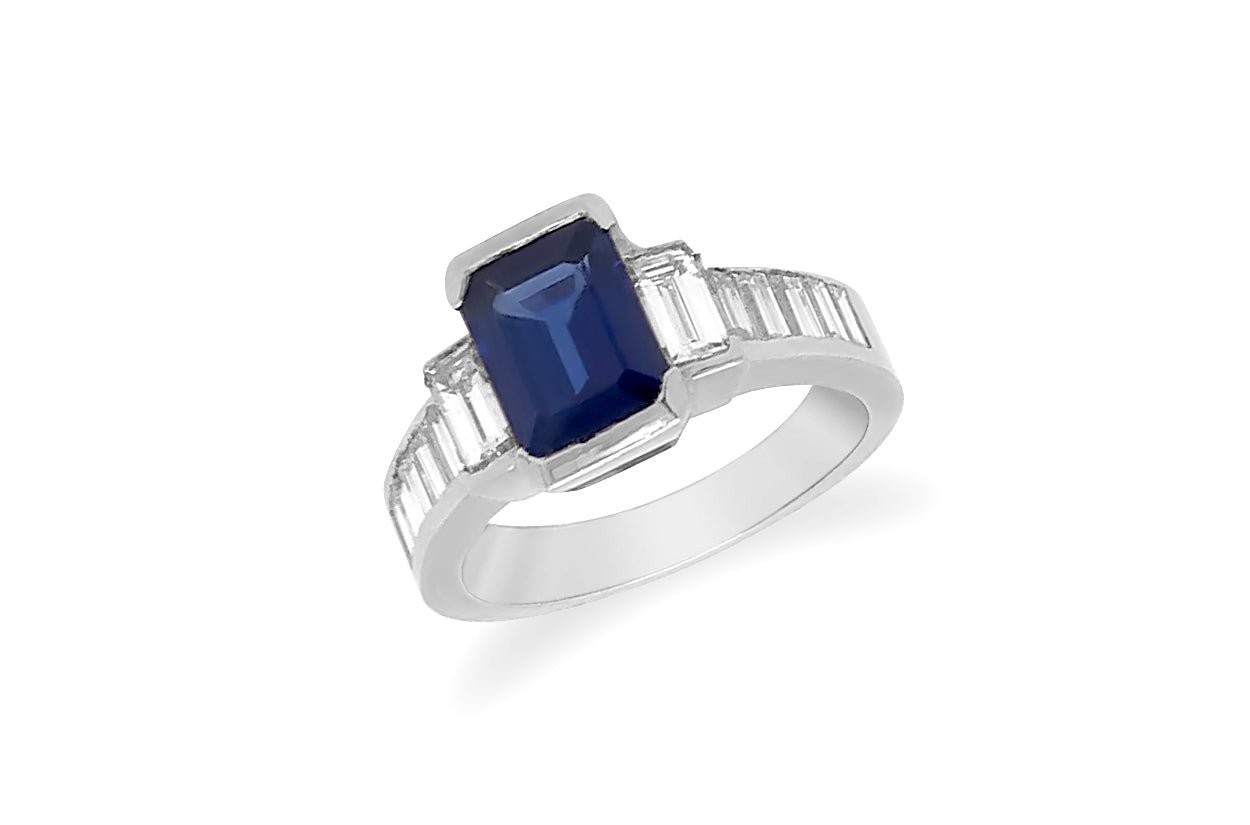 Platinum ring with blue sapphire center and diamond accents